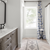 Apartment bathroom with Texas White Ash in 24” x 6” herringbone planks from Good Bones season 8 episode 8