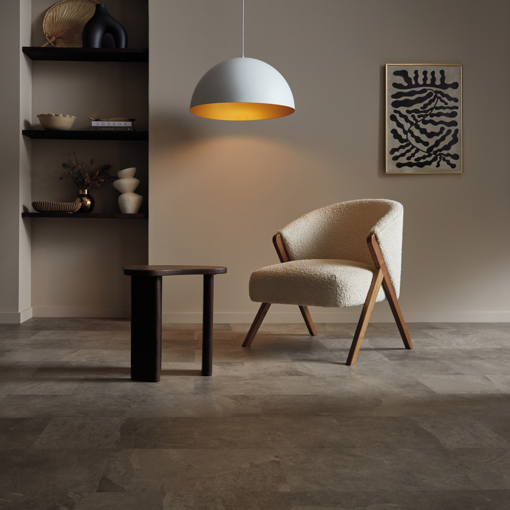 A chair in a moody home study with Grey Riven Slate ST16 floors